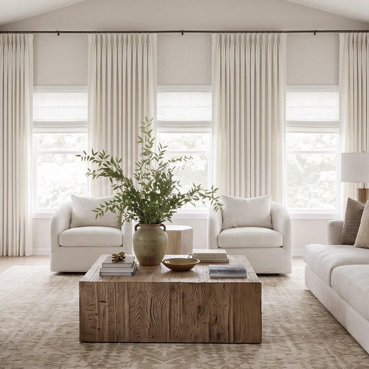 Sunlit new-home living room with custom curtains half-drawn