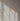 Sunlight streaming through the sheer curtain, casting soft, natural shadow patterns on a light-colored wall, creating a serene indoor ambiance.