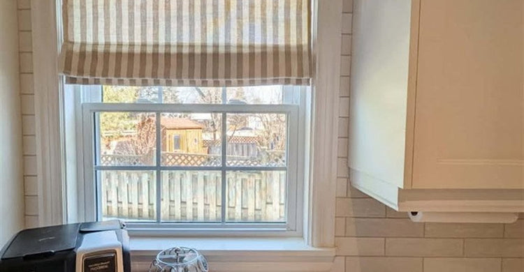 Simple & Calm Co.'s Alfred striped Roman shade over a bright kitchen sink window