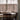 Light gray cafe curtains on a bright kitchen window