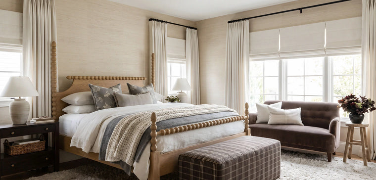 Neutral bedroom with floor-length custom curtains and Roman shades filtering soft natural light