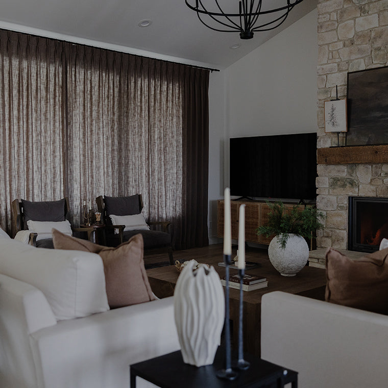 Cozy living room with velvet curtains and fireplace showcasing Curtarra Black Friday and Cyber Monday sale promotions