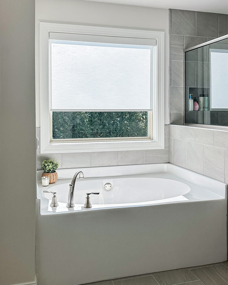 Piper roller shade installed outside mount on street-facing window — showing privacy from outside view