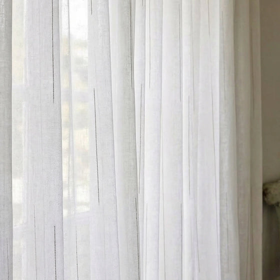 White and Gray, Sheer white curtain panel with a blurred background