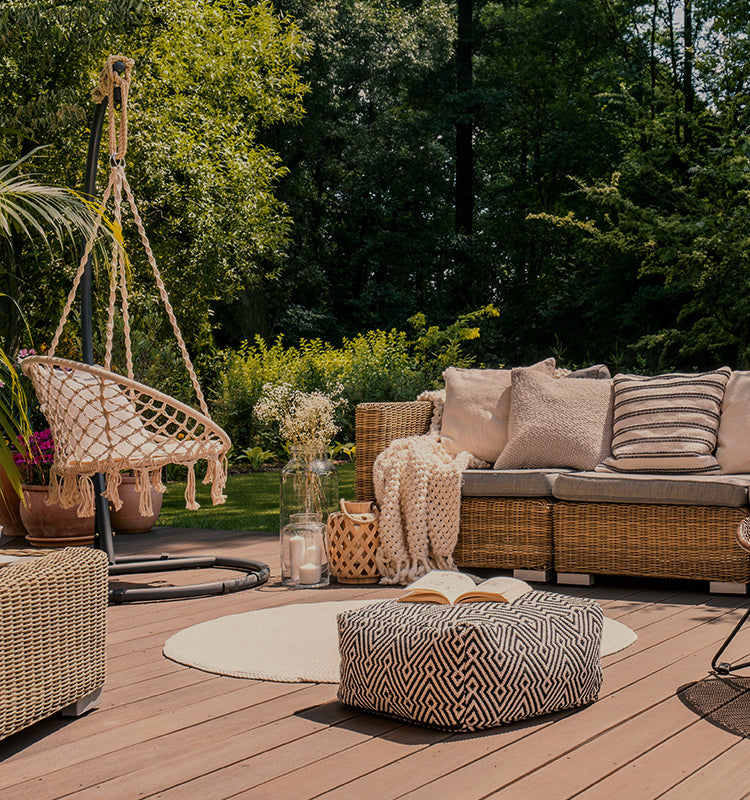 Clark Outdoor Solid Curtains: inviting patio lounge with wicker furniture and hanging chair, perfect for envisioning added privacy and shade.