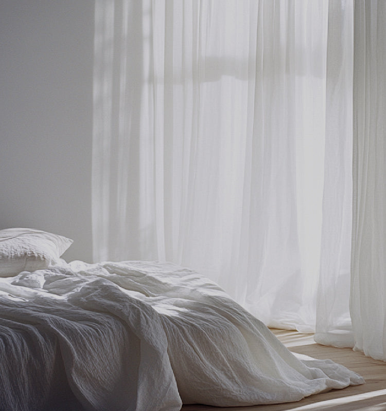 Ella Semi Sheer Curtains softly diffusing sunlight in a peaceful white bedroom, creating a serene ambiance.