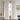 White Snow, curtains hanging in a room with a chair and artwork on the wall.w,