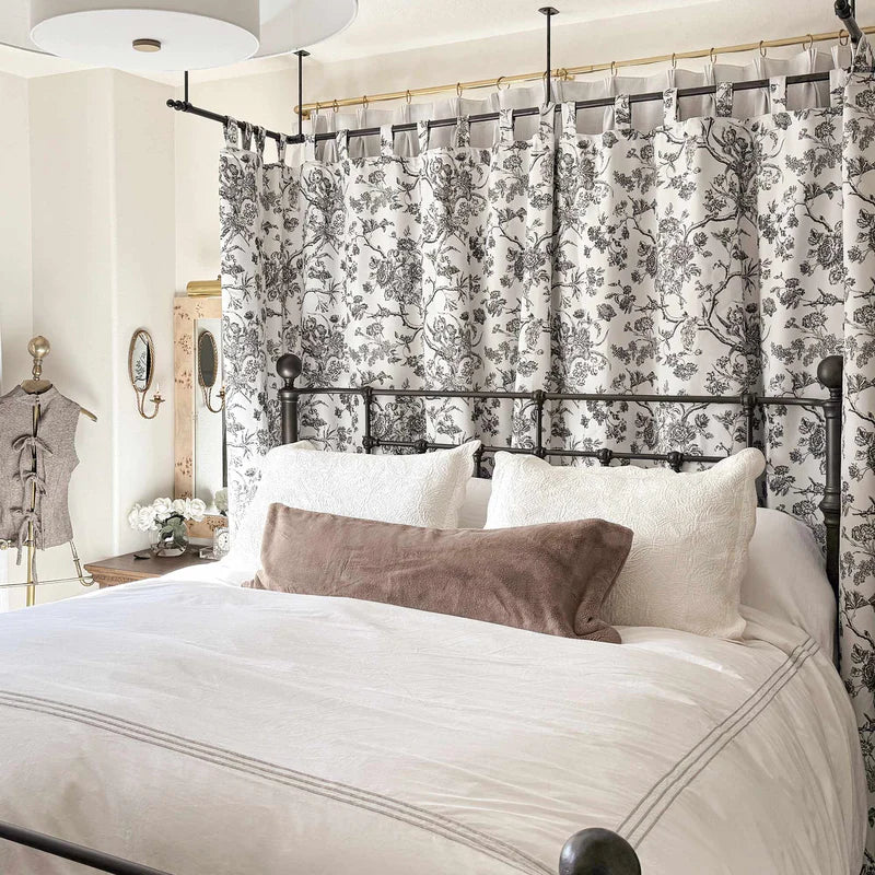 Luxury canopy bed with custom Curtarra curtains showcasing elegant draping and light control