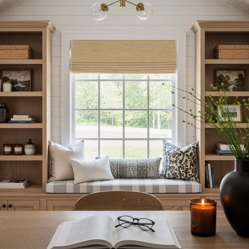 Bamboo and Woven Wood Shades Filtering Warm Natural Light in a Living Room