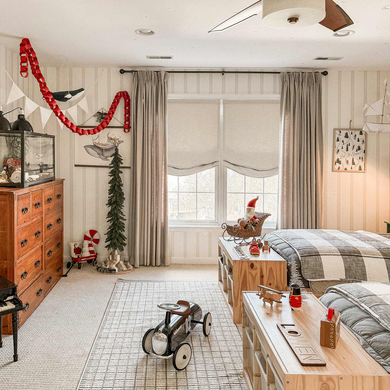 Earthy tone curtains styled floor-to-ceiling with pinch pleat heading in a warm-toned living room