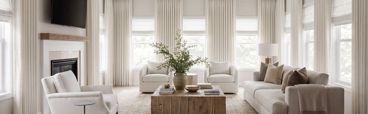 Sunlit new-home living room with custom curtains half-drawn