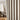Curtarra custom curtain with a lamp and wooden cabinet in the background