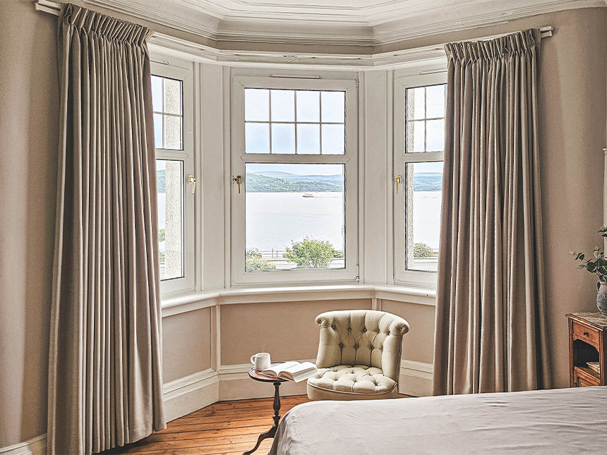 Perfectly fitted custom curtains on non-standard windows in a designer home