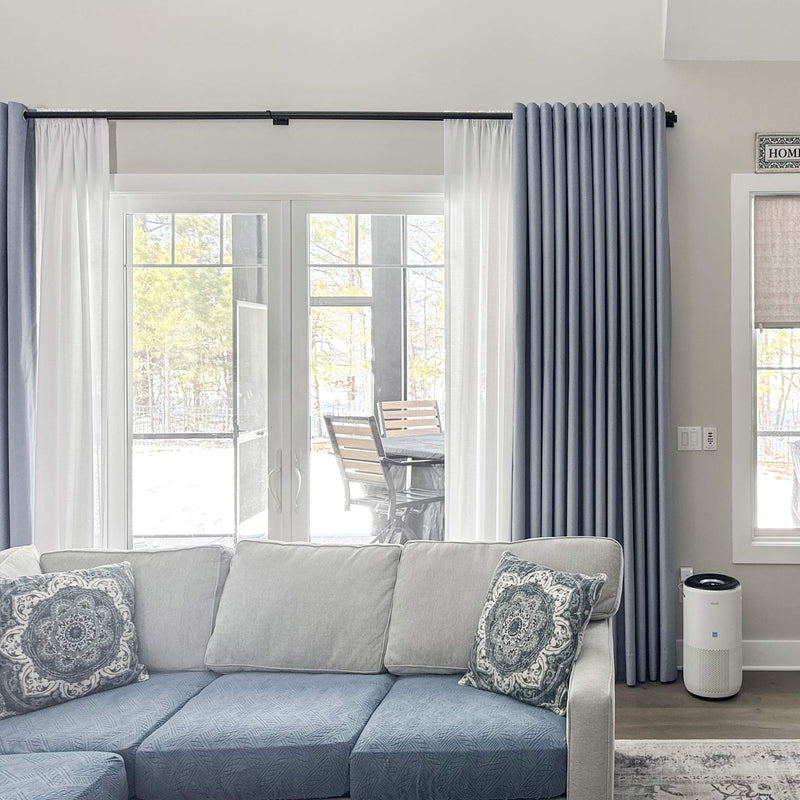 Window treatment specialist demonstrating privacy curtain fabric options