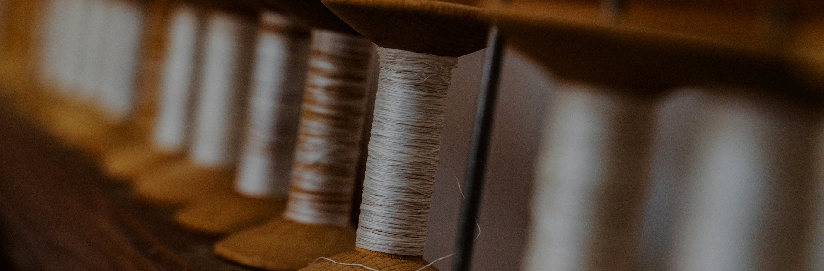 Close-up of spools of thread on a wooden reel