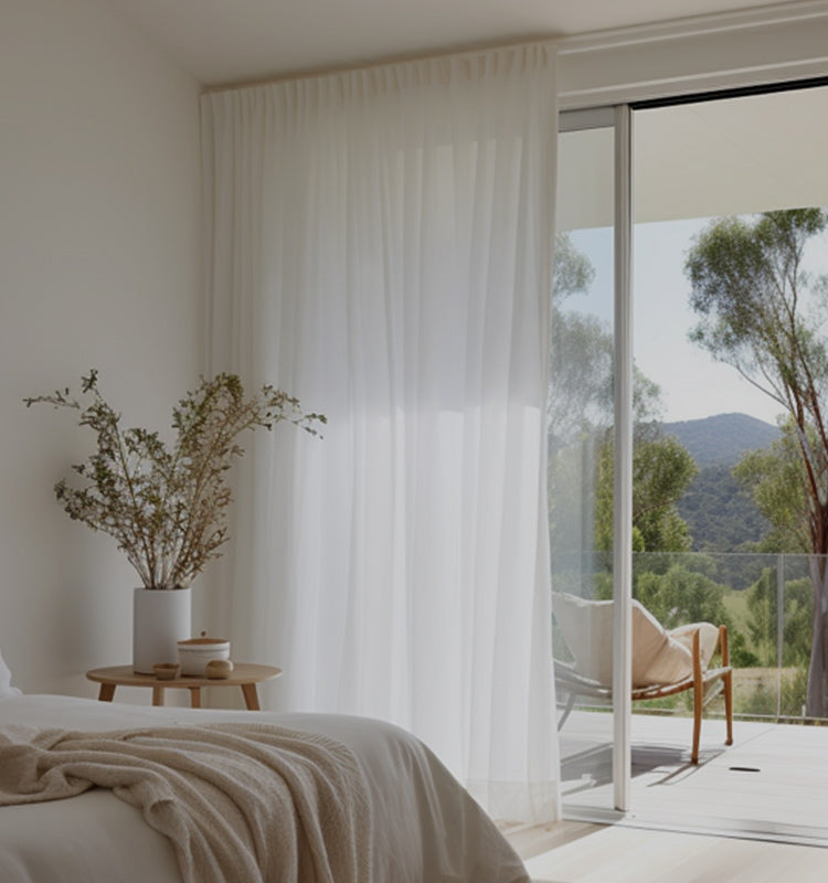 Margaret Durable Solid Sheer Curtains softly filter sunlight in a serene bedroom, enhancing privacy and natural light.