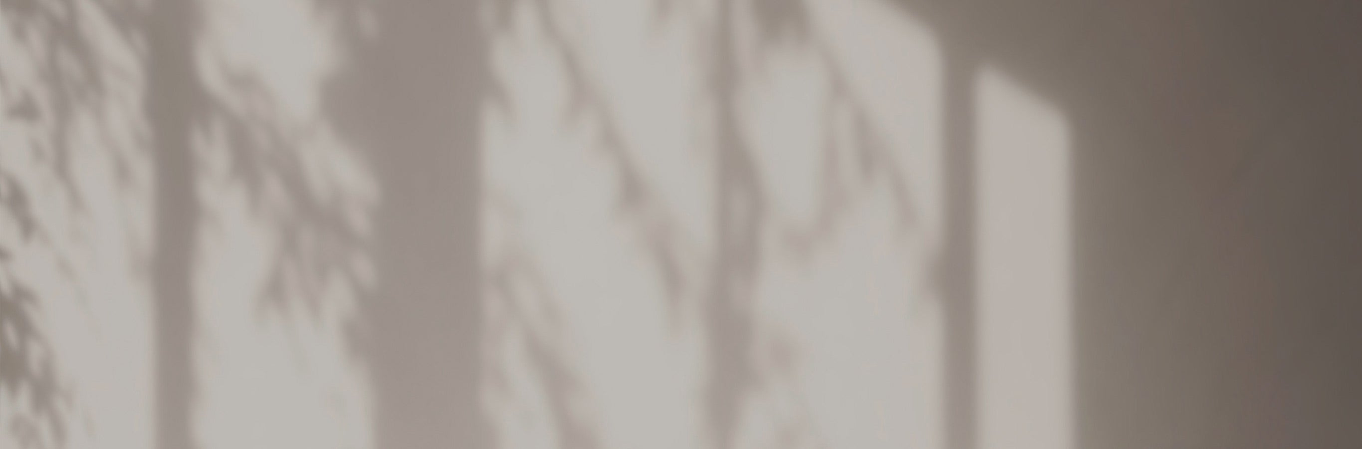 Soft shadows from sunlight filtered by Natasha Linen Look Outdoor Sheer Curtains creating gentle patterns on a wall, enhancing natural lighting.