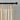 Beige pencil pleat curtains with a black curtain rod against a gray wall