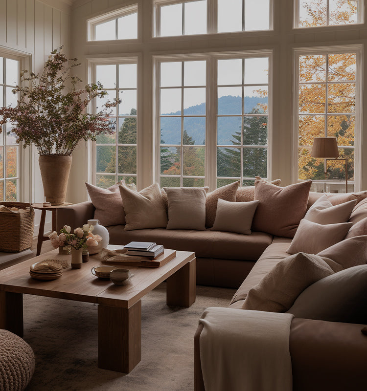 Cozy living room with expansive windows, hinting at custom Curtarra Scott curtains managing natural light.