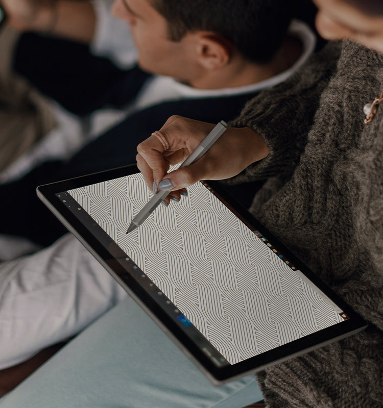 A person designing custom made Spencer Braid Weave Texture Curtains on a tablet, highlighting the pattern's digital visualization.